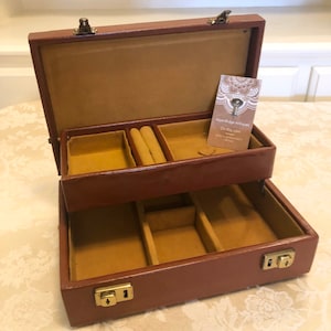 60s Cheney Quilted England Footed Wine And Gold Jewelry Box With Gold Orange Felt Lining. This Jewelry Box has Original key
