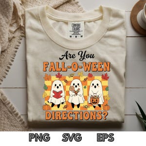 Puede incluir: Camiseta color crema con el texto "Are You FALL-O-WEEN DIRECTIONS?" y un gráfico de tres fantasmas de dibujos animados. Los fantasmas sostienen un libro, caramelos y una linterna de calabaza. La camiseta tiene cuello redondo y mangas cortas.