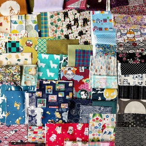 May include: A selection of patterned fabric swatches in a variety of colours. Designs include animals, flowers, and geometric shapes. The fabrics are in shades of yellow, blue, red, and green, suitable for crafts and quilting.