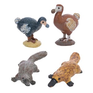 May include: Four miniature animal figurines: two dodos and two platypuses. The dodos are brown and blue, while the platypuses are gray and brown. The figurines are made of a solid material and are set against a white background.