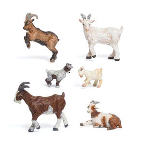 May include: A set of six goat figurines in different poses. The goats are in shades of brown, white, and tan, with detailed horns and hooves. One goat is rearing up on its hind legs, while another is lying down. These miniature farm animal toys are suitable for play or display.