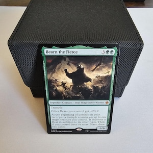 May include: A Magic: The Gathering trading card titled Beorn the Fierce, featuring a green border and an illustration of a large bear in a battle scene. The card text includes the creature type Bear Shapeshifter Warrior, power and toughness 6/6.