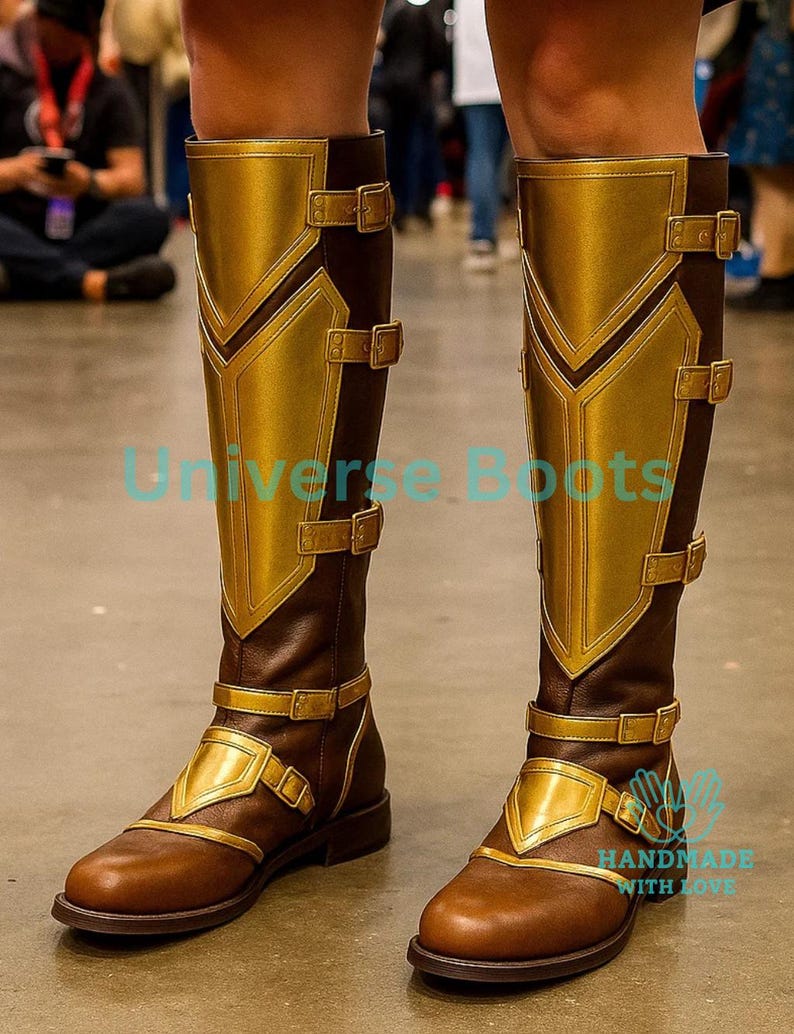 May include: Brown and gold knee-high boots with decorative gold panels and buckles. The boots have a brown base with gold accents and are designed with multiple straps and buckles. The text "Universe Boots" is visible on the boots.