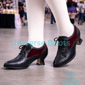 May include: Black leather lace-up shoes with burgundy velvet accents. The shoes have a small heel and a classic design. The text "Universe Boots" and "HANDMADE WITH LOVE" are visible on the image.