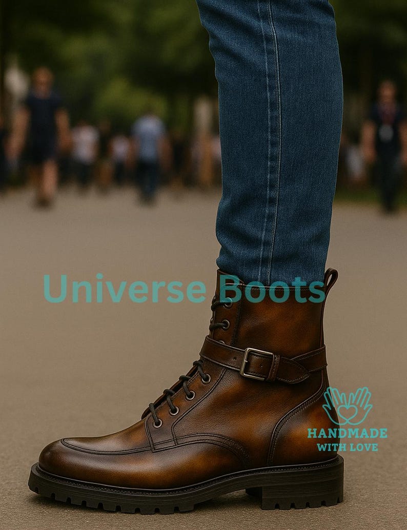 May include: Brown leather boots with a buckle strap and lace-up closure. The boots have a rounded toe and a thick, dark sole. The text "Universe Boots" and "HANDMADE WITH LOVE" are visible on the image.