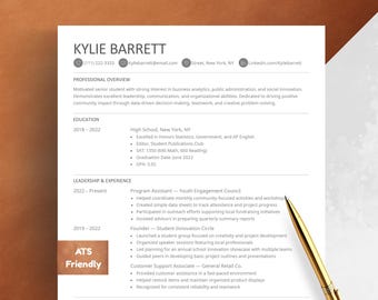 May include: A resume template with the name Kylie Barrett at the top, contact information, and sections for professional overview, education, and leadership experience. A gold pen rests on the document. The resume is ATS friendly.