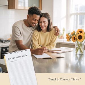 May include: A couple smiles while looking at a "Kitchen starter guide" notebook. The notebook is open on a stainless steel countertop. A vase of sunflowers sits in the background. The text "Simplify. Connect. Thrive." is at the bottom.