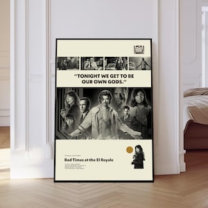 May include: A framed black and white movie poster for "Bad Times at the El Royale." The poster features a cast of characters and the quote, "TONIGHT WE GET TO BE OUR OWN GODS." The poster has a vintage aesthetic.