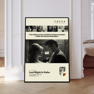 May include: A framed movie poster for "Last Night in Soho" in black and white. The poster features a quote, "THE WORLD IS FULL OF PEOPLE TRYING TO FORGET. I THINK WE SHOULD REMEMBER." The poster is displayed in a room with white walls and a wooden floor.