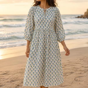 Women’s printed cotton midi dress with 3/4 sleeves, flowy tiered skirt, and blue floral pattern on beige fabric, casual boho style