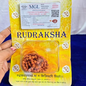 May include: A packaged Rudraksha Mala, a strand of brown beads, is displayed. The packaging is yellow with text in English and Hindi, including "RUDRAKSHA" and details from the Maya Gemological Laboratory. The beads are approximately 4.5 mm in size.