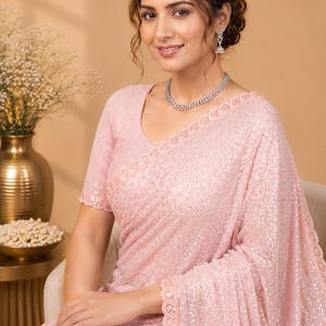 Stylish peach party wear saree with sparkling sequins and contemporary festive look