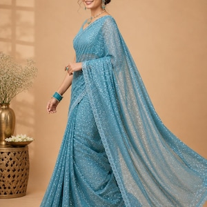 Designer sequin saree in icy blue shade with modern sleeveless blouse for evening parties