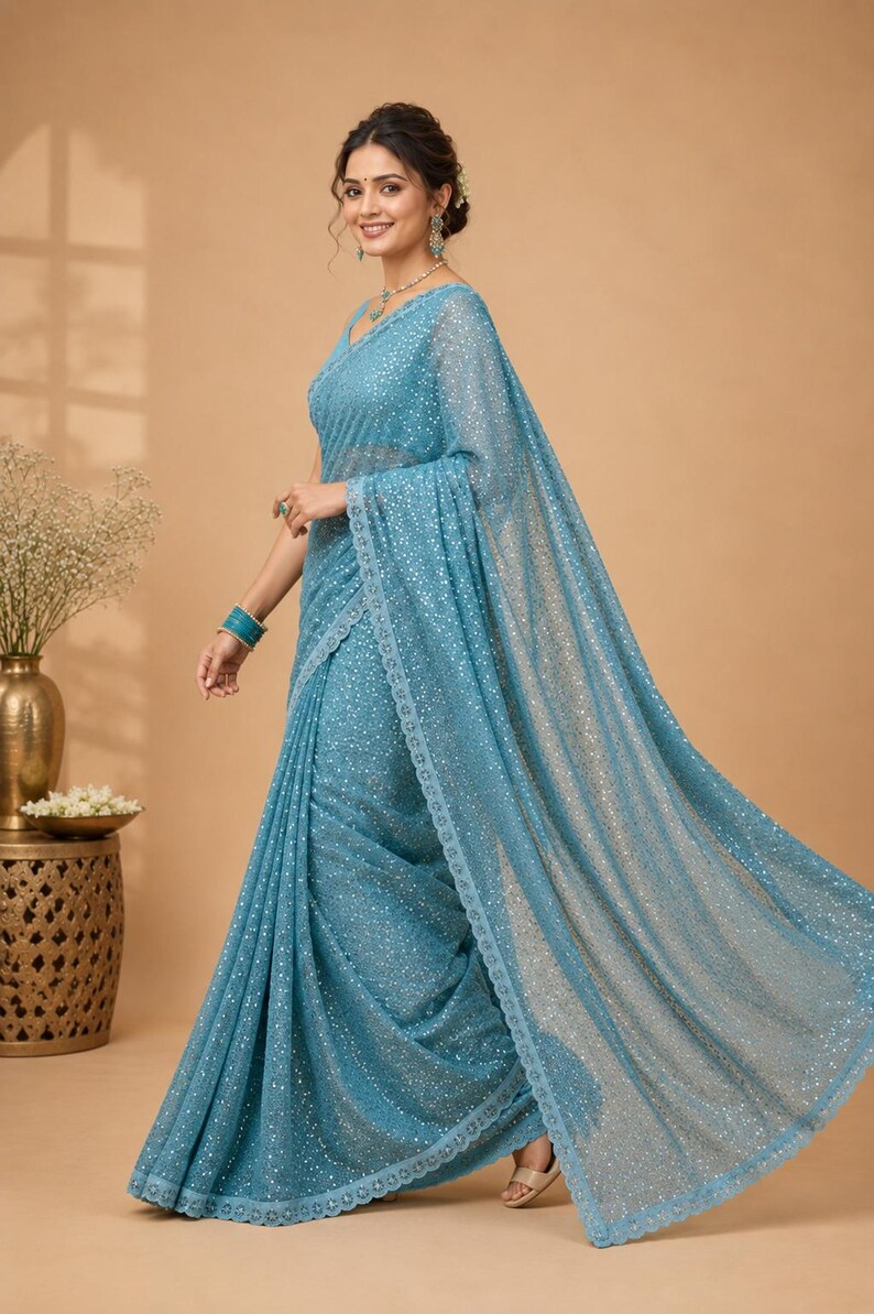 Designer sequin saree in icy blue shade with modern sleeveless blouse for evening parties