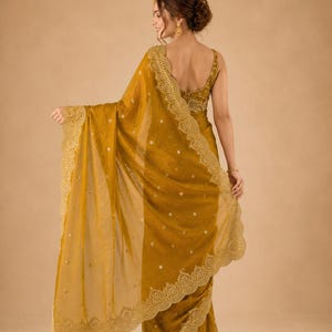 Back pose of Women wearing golden Embroidered Fendy Chiffon Saree for wedding, Party wear Outfit for UK Girls