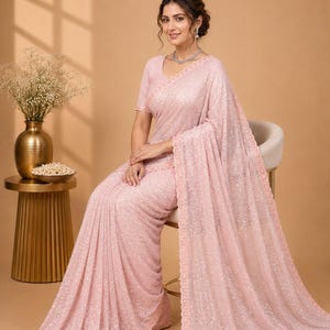 Luxury peach saree with glitter embellishments and sophisticated ethnic party style