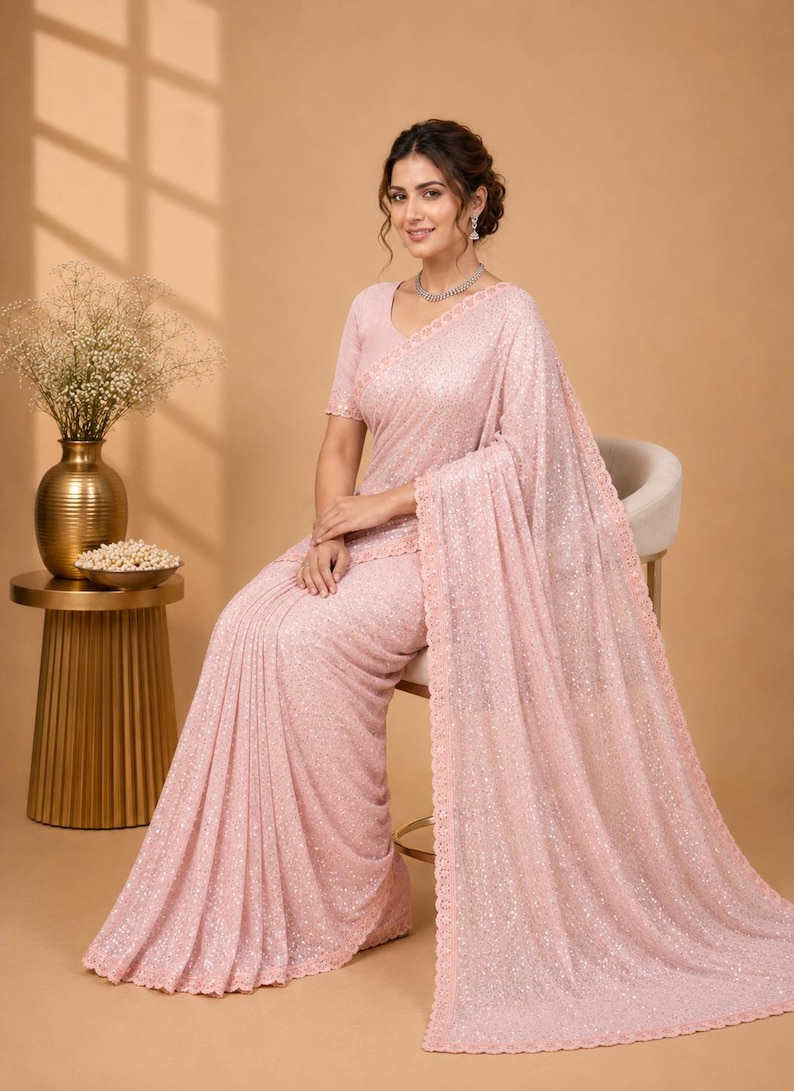 Luxury peach saree with glitter embellishments and sophisticated ethnic party style