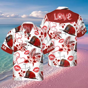 May include: White Hawaiian shirt with a red collar and sleeves, featuring a pattern of red firefighter helmets, hearts, lips, and floral elements. The word "LOVE" is on the back of the collar. The names "ELLEN" and "JOHN" are on the sleeves.