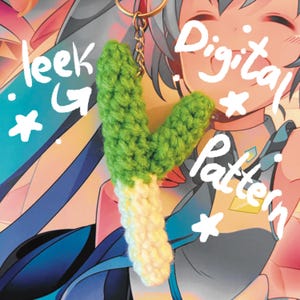 May include: A handmade crochet leek keychain with a gold-colored chain. The leek is green and white, with the text "leek" and "Digital Pattern" in white. The background features an anime-style illustration.