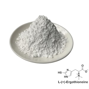 May include: A white powder is piled on a white ceramic plate. The powder has a textured appearance. A chemical structure diagram of L-(+)-Ergothioneine is in the lower right corner.