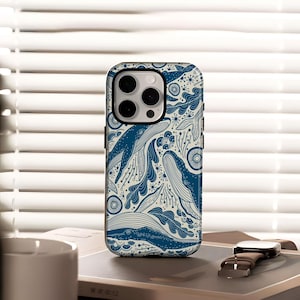 May include: A phone case featuring a blue and white whale pattern. The design includes illustrations of whales, waves, and other marine elements. The case has a black border and a camera cutout.