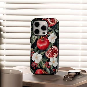 May include: Black phone case featuring a vibrant floral design with red pomegranates, white flowers, and green leaves. The case has a glossy finish and a camera cutout. The design is a botanical illustration.