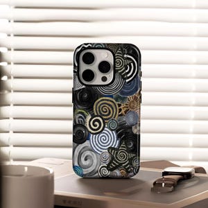 May include: A smartphone case with a black and white spiral design. The case features a variety of spiral patterns in black, white, gold, and blue. A star-shaped spiral is also visible. The case is designed for a smartphone.