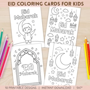 May include: Four white coloring cards with the text "Eid Mubarak" and illustrations of a crescent moon, stars, and lanterns. Colouring pencils are visible on the left and right. The cards are 12.7 x 17.8 cm.