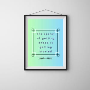 May include: A framed print with a black border, displaying the quote "The secret of getting ahead is getting started." The background transitions from green to blue. The text is in a dark blue font, framed by a white and black border.