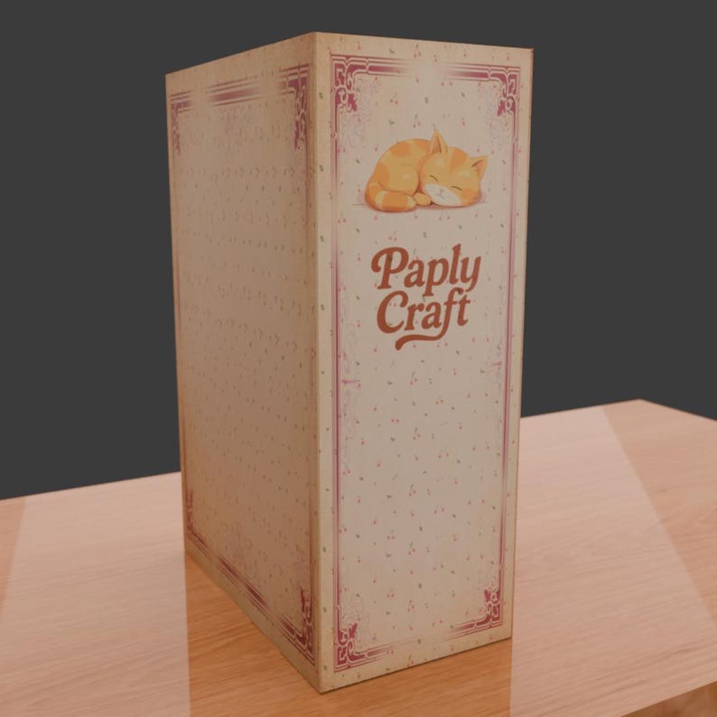 Puede incluir: Una caja rectangular con un dise&ntilde;o vintage. La caja presenta una ilustraci&oacute;n de un gato naranja durmiendo y el texto "Paply Craft" en una fuente estilizada. La caja tiene un fondo color crema con un patr&oacute;n de puntos y bordes rosas decorativos.