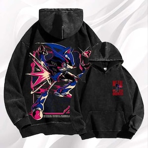 May include: Two black hoodies with a distressed wash. One features a large graphic of a blue and red character in action. The other has a smaller graphic with the text "METAL SONIC" in red.