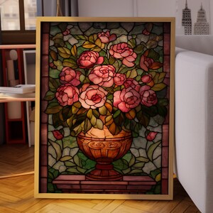 May include: A framed stained glass artwork featuring a vase overflowing with pink roses. The vase is a warm copper color, and the background is a mosaic of green and amber glass. The frame is gold.