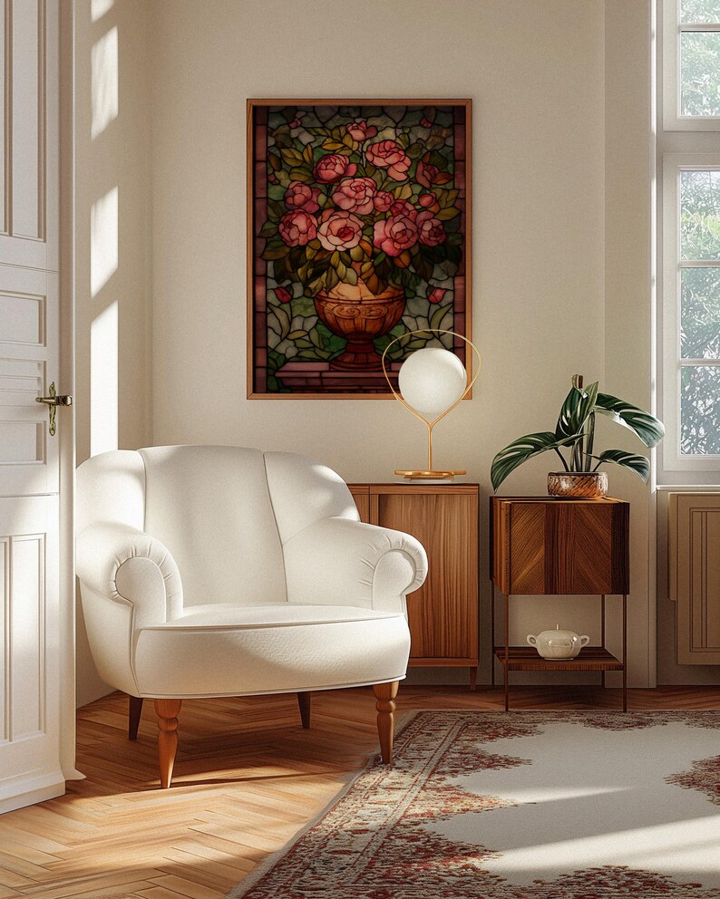 May include: A cozy living room scene featuring a white armchair, a stained glass artwork of roses in a vase, and a decorative lamp. A wooden side table holds a potted plant and a small decorative bowl. A patterned rug adds warmth.
