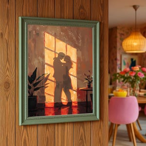 May include: A framed painting depicts a couple embracing in front of a sunlit window. The artwork features warm tones of orange and brown, with a green frame. A potted plant and small table are visible.