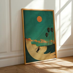 May include: Framed art print featuring a skateboarder in a skate bowl under a teal sky with an orange sun. Palm trees and clouds are in the background. The artwork has a vintage, retro style with a wooden frame.