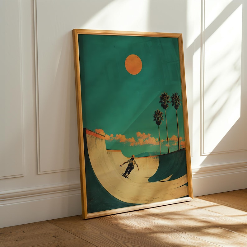 May include: Framed art print featuring a skateboarder in a skate bowl under a teal sky with an orange sun. Palm trees and clouds are in the background. The artwork has a vintage, retro style with a wooden frame.