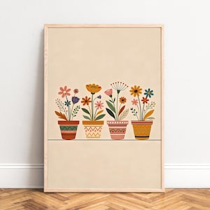 May include: A framed art print featuring four potted flowers with colorful blooms. The pots are decorated with geometric patterns in shades of orange, red, and yellow. The background is a light beige color.
