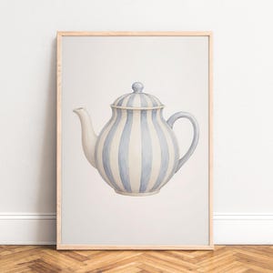May include: A framed wall art print featuring a centred illustration of a teapot with vertical light blue and cream stripes. The teapot has a rounded body, a curved spout, a matching lid with a small knob, and a curved handle, all in a soft style.