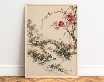 May include: A framed wall art print featuring a watercolor-style landscape painting of a stone arch bridge over a flowing stream, surrounded by rocky terrain and a tree with delicate pink and red blossoms against a light beige background.