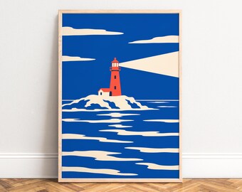 May include: A framed art print featuring a vibrant red lighthouse on a rocky island surrounded by deep blue water. The lighthouse emits a wide, pale yellow beam of light across a dark blue sky with stylized cream-colored clouds.