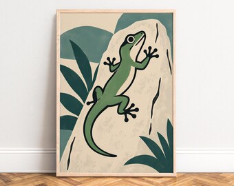 May include: A framed wall art print featuring a green lizard with a cream-colored underbelly climbing a large, textured beige rock. The background includes dark green foliage shapes and soft blue-green curved forms in a flat, graphic style.