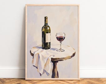 May include: A framed painting depicting a dark green wine bottle and a glass filled with red wine resting on a round table. A white cloth hangs over the edge of the table. The artwork features a light-colored background and a wooden frame.