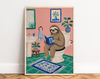 May include: A framed wall art print featuring a brown sloth sitting on a white toilet in a pink bathroom with green tiled floors. The sloth is reading a blue book. The room includes a white sink, a blue and white rug, and potted plants.