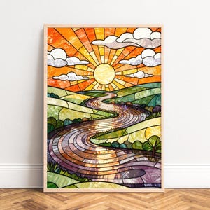 May include: A framed stained glass art piece depicting a landscape scene. The artwork features a vibrant orange and yellow sun, white clouds, and a winding river flowing through green hills. The piece is framed in a light wood.