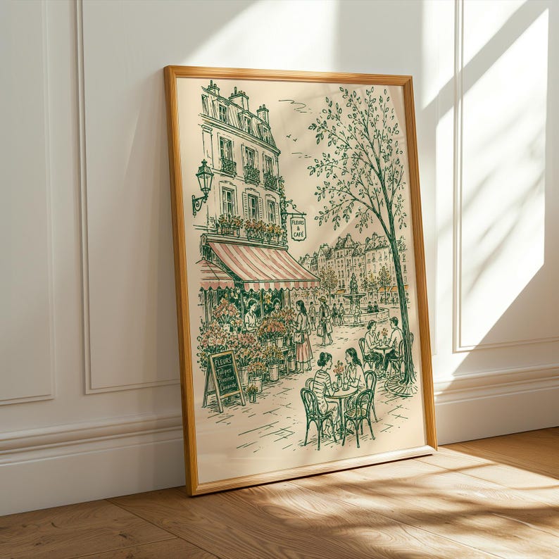 Puede incluir: Una l&aacute;mina de arte enmarcada con un dibujo lineal detallado de una escena callejera parisina con una florister&iacute;a, mesas de caf&eacute; al aire libre y personas. La ilustraci&oacute;n incluye un cartel que dice "FLEURS A CAFE" y una pizarra con texto.