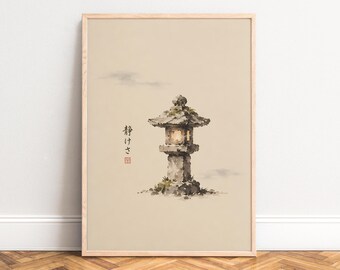May include: A framed wall art print featuring a watercolor illustration of a stone lantern with a glowing light. The artwork is set against a beige background and includes Japanese text characters and a small red square stamp on the left side.