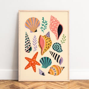 May include: A framed art print featuring a collection of colorful seashells and starfish. The artwork showcases various shell shapes and patterns in shades of orange, pink, blue, yellow, and purple, set against a cream background.