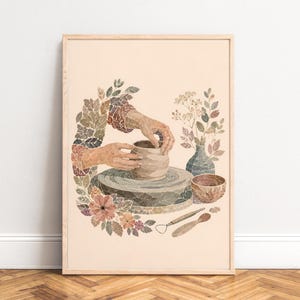 May include: A framed art print featuring a collage-style illustration of hands shaping a clay pot on a pottery wheel. The scene includes a small vase with flowers, a bowl, and two sculpting tools, all surrounded by a wreath of autumn-toned leaves.