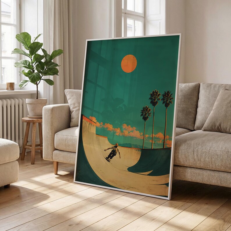 May include: A framed art print featuring a skateboarder in a skate bowl under a vibrant orange sun. The artwork has a retro aesthetic with palm trees and a teal sky. The print is displayed in a living room setting.