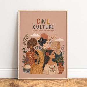 May include: A vertical wall art print on a muted pink background featuring the text ONE CULTURE MANY STORIES, ONE HUMANITY. The illustration depicts five diverse figures in various traditional garments, surrounded by botanical elements and two vases.